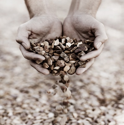 Letting the stones fall. Closeup of two hands holding gravel